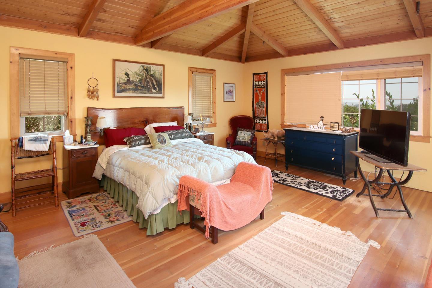 434 Old Smith Road Watsonville, CA 95076 - Photo 24 of 61 a bedroom with a bed a bookshelf a desk and chair with the garden view