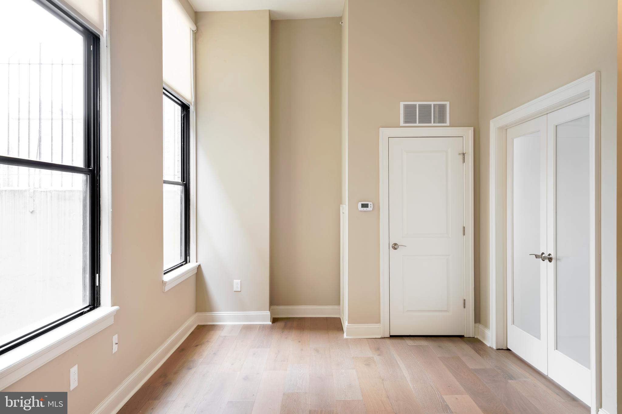 33 Letitia Street, Unit 306 Philadelphia, PA 19106 - Photo 21 of 24 an empty room with wooden floor and a window