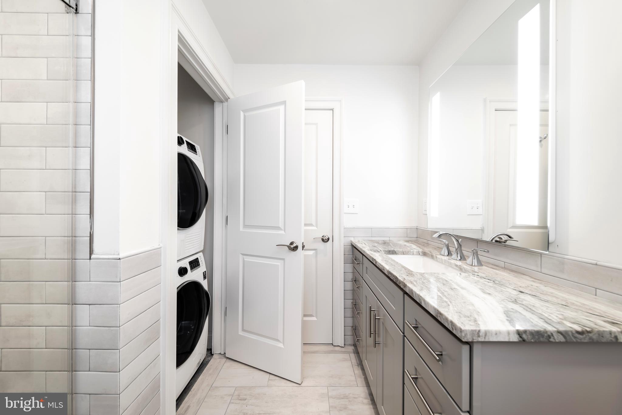 33 Letitia Street, Unit 306 Philadelphia, PA 19106 - Photo 24 of 24 a bathroom with a granite countertop sink and a mirror