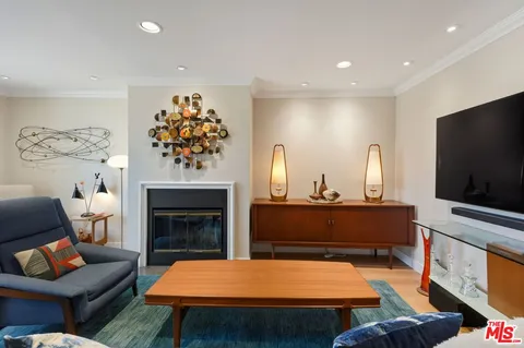 a living room with furniture fireplace and flat screen tv