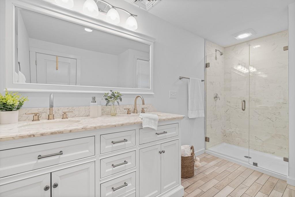 23 Williams Road Concord, MA 01742 - Photo 14 of 32 a bathroom with a granite countertop sink mirror and shower
