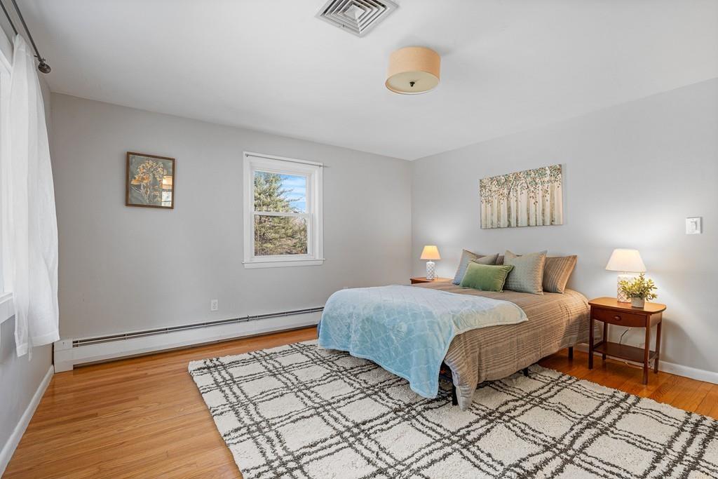 23 Williams Road Concord, MA 01742 - Photo 15 of 32 a bedroom with a bed and wooden floor