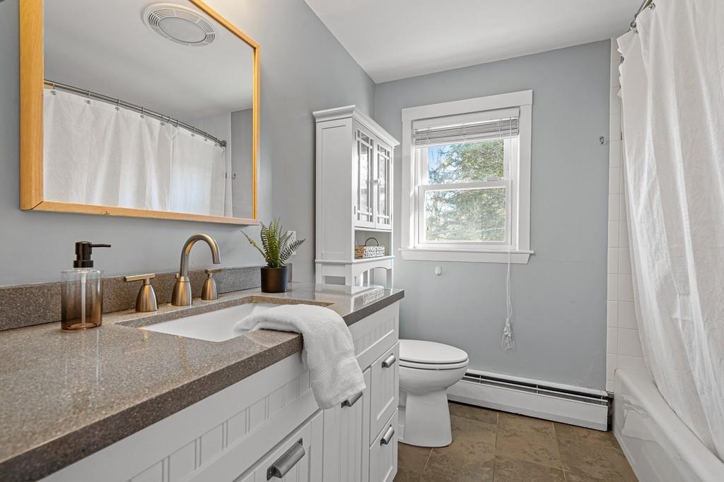 23 Williams Road Concord, MA 01742 - Photo 17 of 32 a bathroom with a granite countertop sink mirror vanity and toilet
