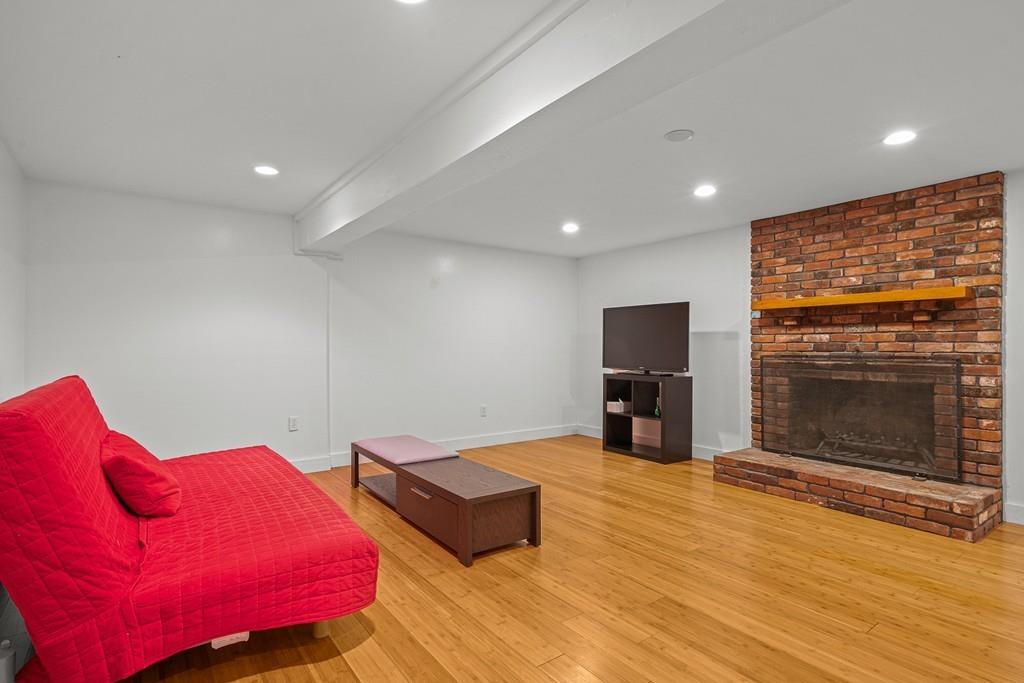 23 Williams Road Concord, MA 01742 - Photo 20 of 32 a living room with furniture and a fireplace