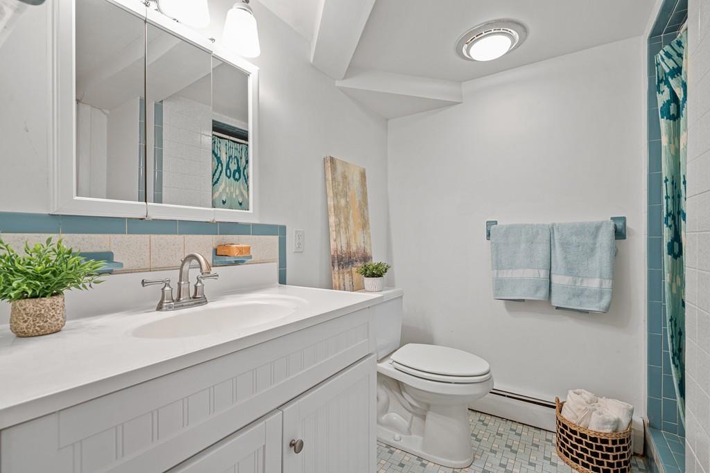 23 Williams Road Concord, MA 01742 - Photo 24 of 32 a bathroom with a sink a toilet and mirror