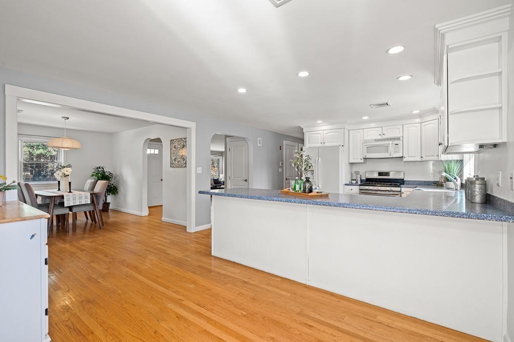 23 Williams Road Concord, MA 01742 - Photo 5 of 32 a large white kitchen with lots of counter top space and stainless steel appliances