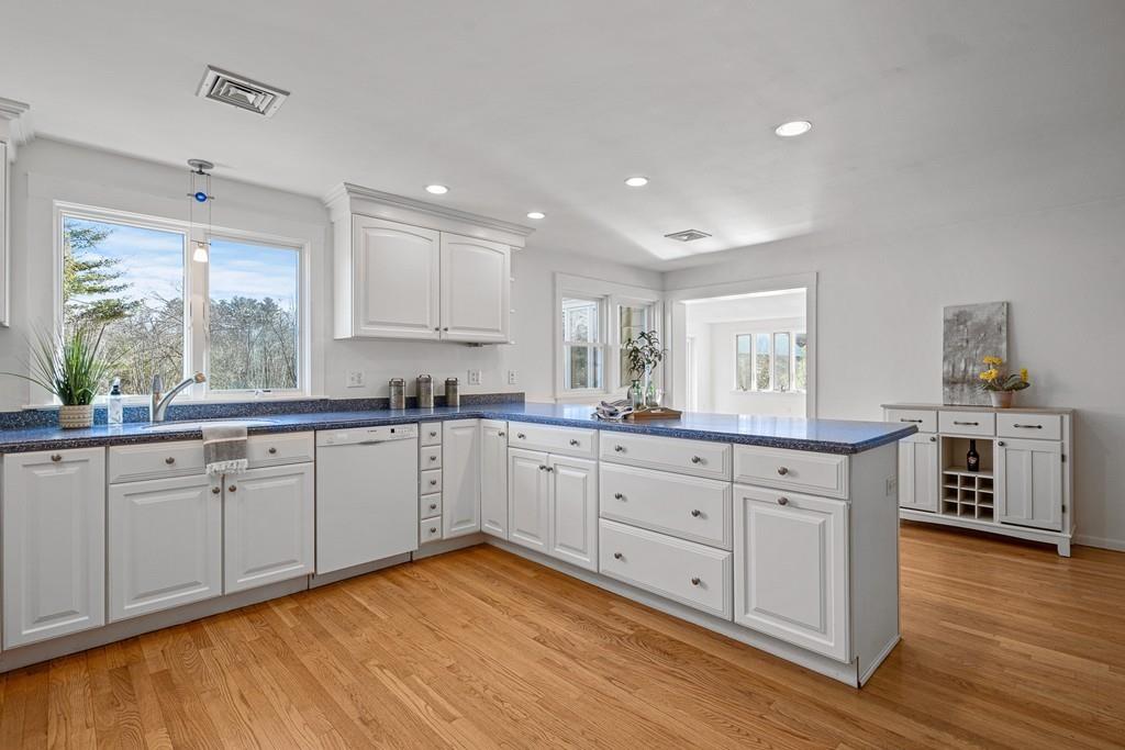 23 Williams Road Concord, MA 01742 - Photo 6 of 32 a kitchen with granite countertop white cabinets and white appliances