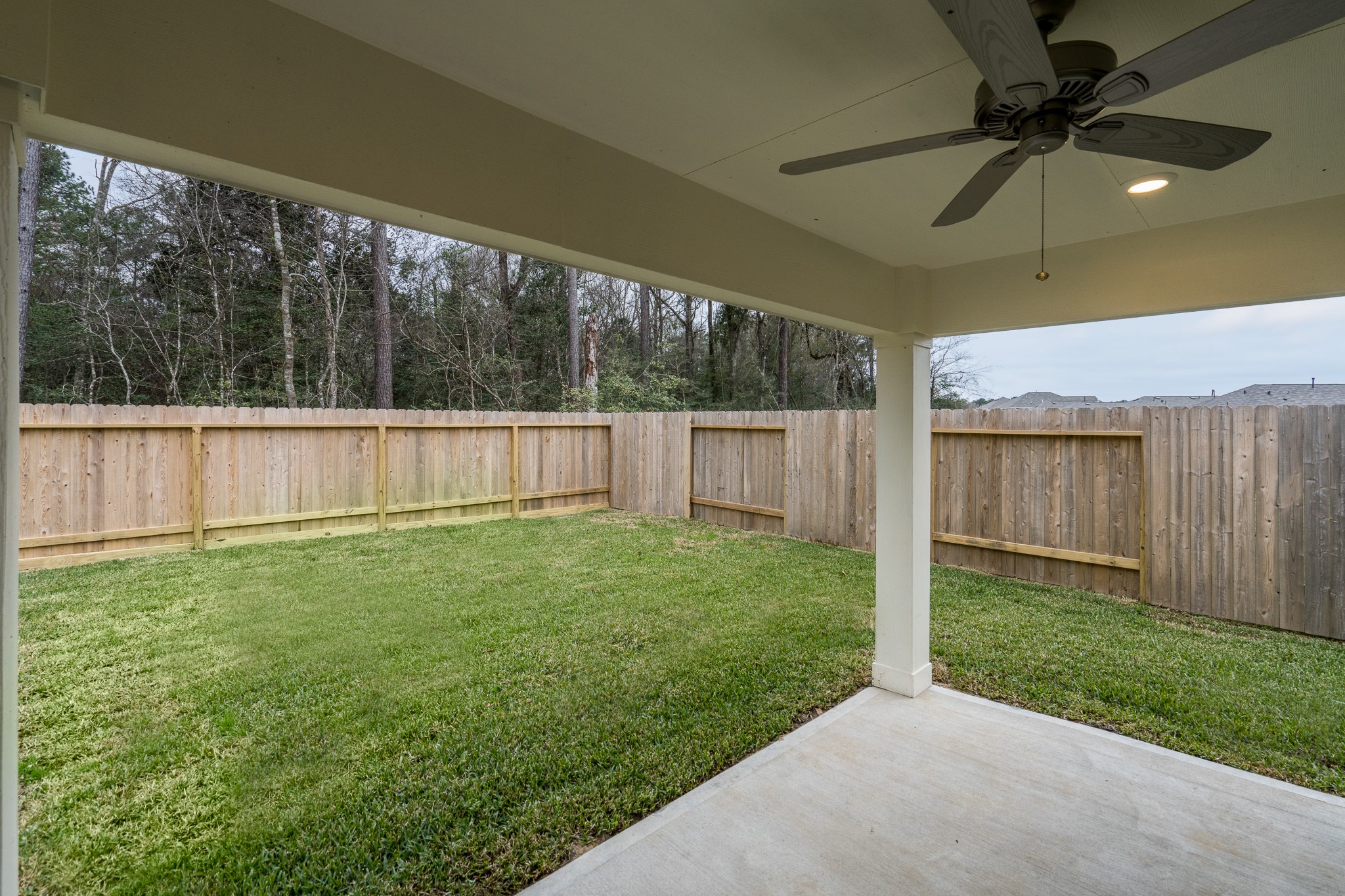 17536 Rosewood Manor Lane New Caney, TX 77357 - Photo 1 of 27 a view of a backyard with a garden and a ceiling fan