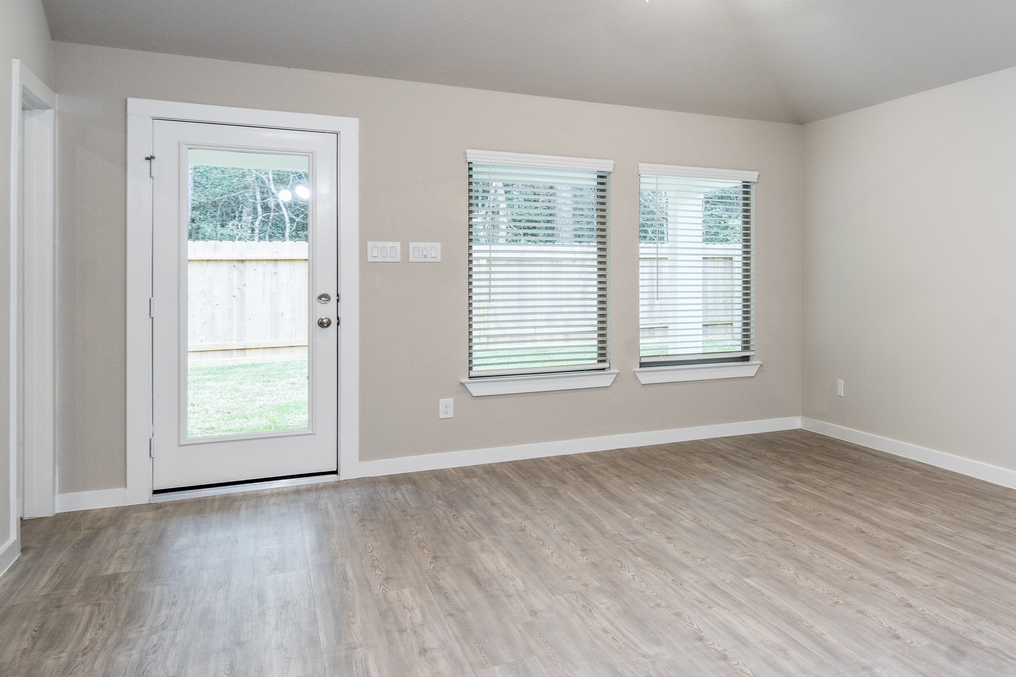 17536 Rosewood Manor Lane New Caney, TX 77357 - Photo 11 of 27 an empty room with wooden floor and windows