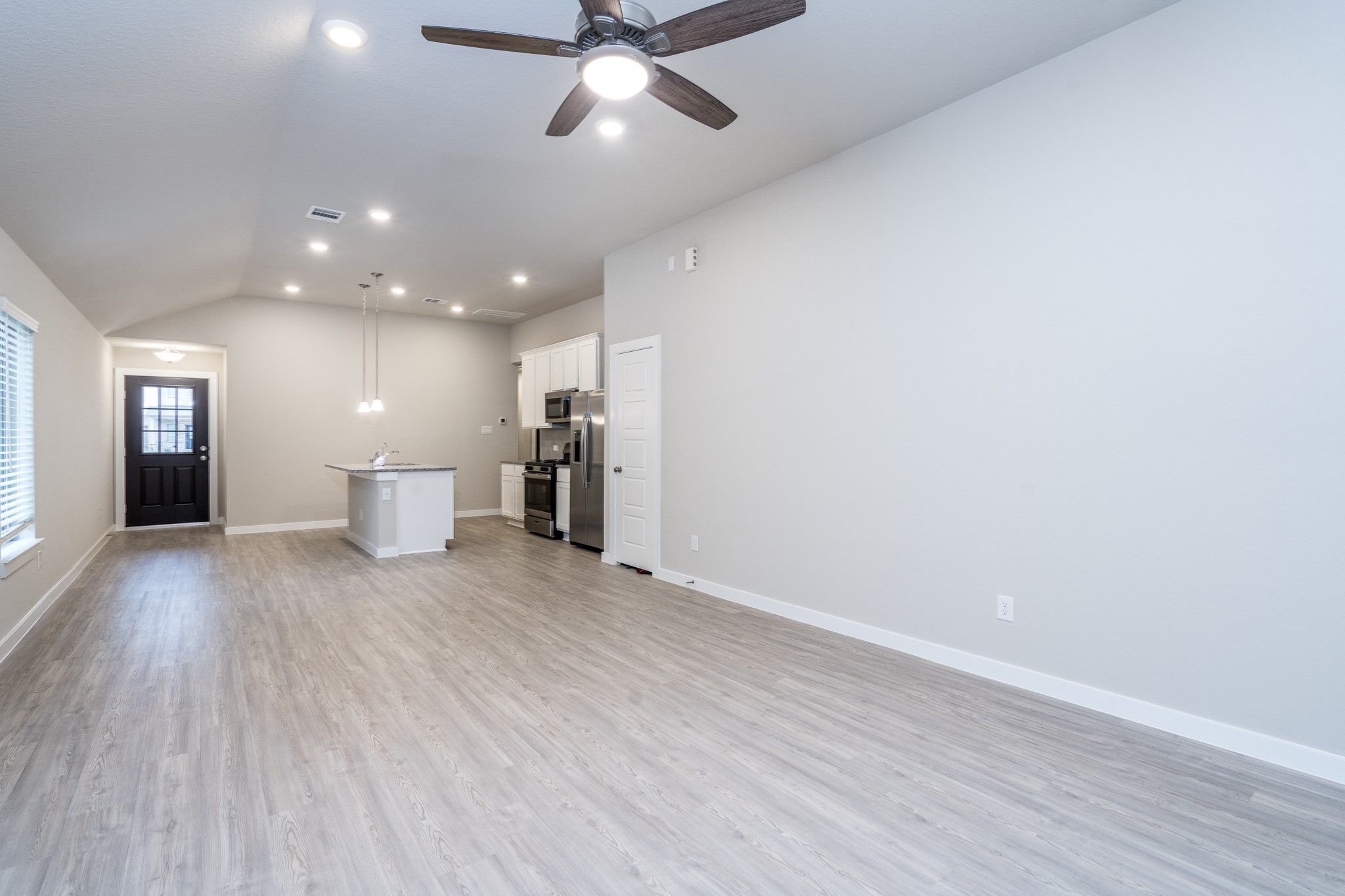 17536 Rosewood Manor Lane New Caney, TX 77357 - Photo 12 of 27 a view of a livingroom with a hardwood floor and a ceiling fan