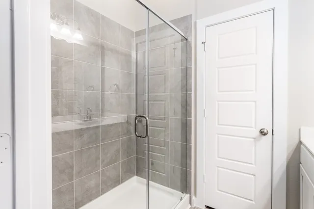 a bathroom with a glass shower door