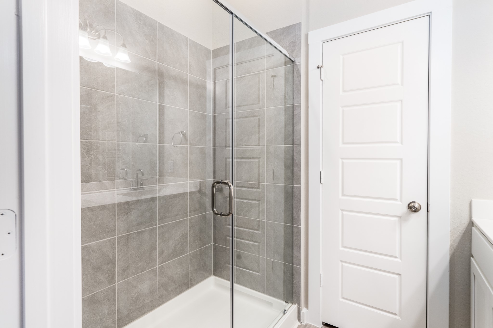 17536 Rosewood Manor Lane New Caney, TX 77357 - Photo 14 of 27 a bathroom with a glass shower door