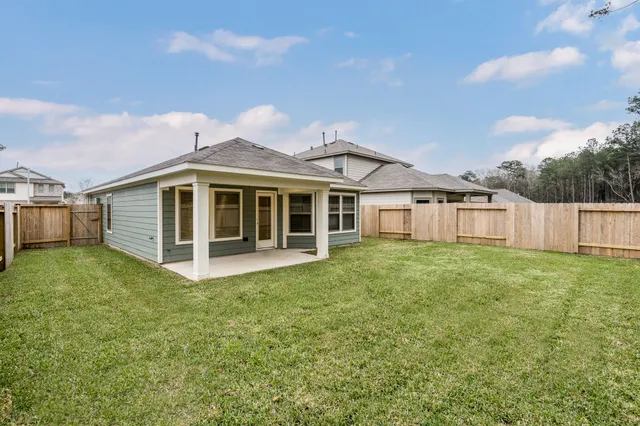 a view of a house with a yard and sitting area
