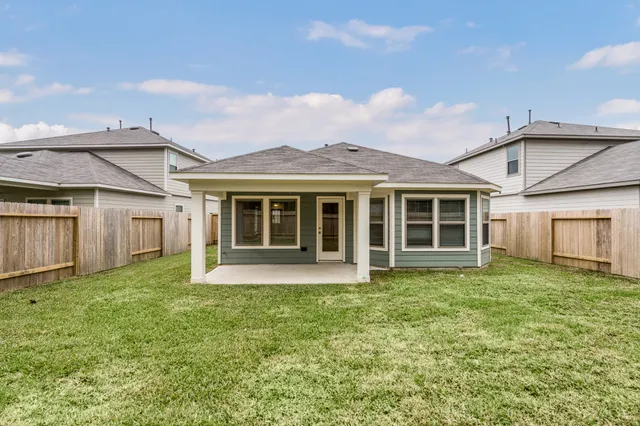 a view of a house with a garden and yard