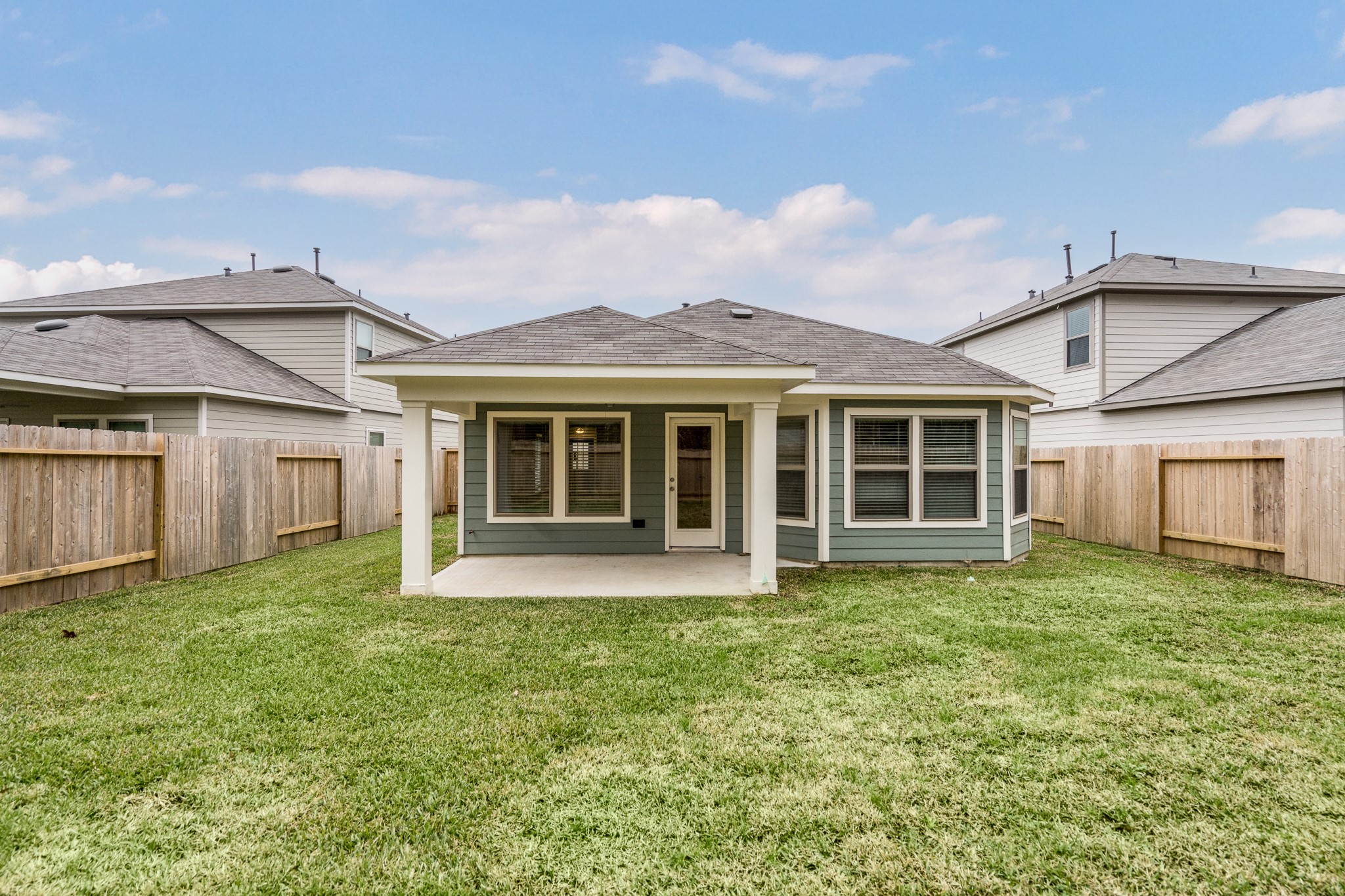 17536 Rosewood Manor Lane New Caney, TX 77357 - Photo 22 of 27 a view of a house with a garden and yard