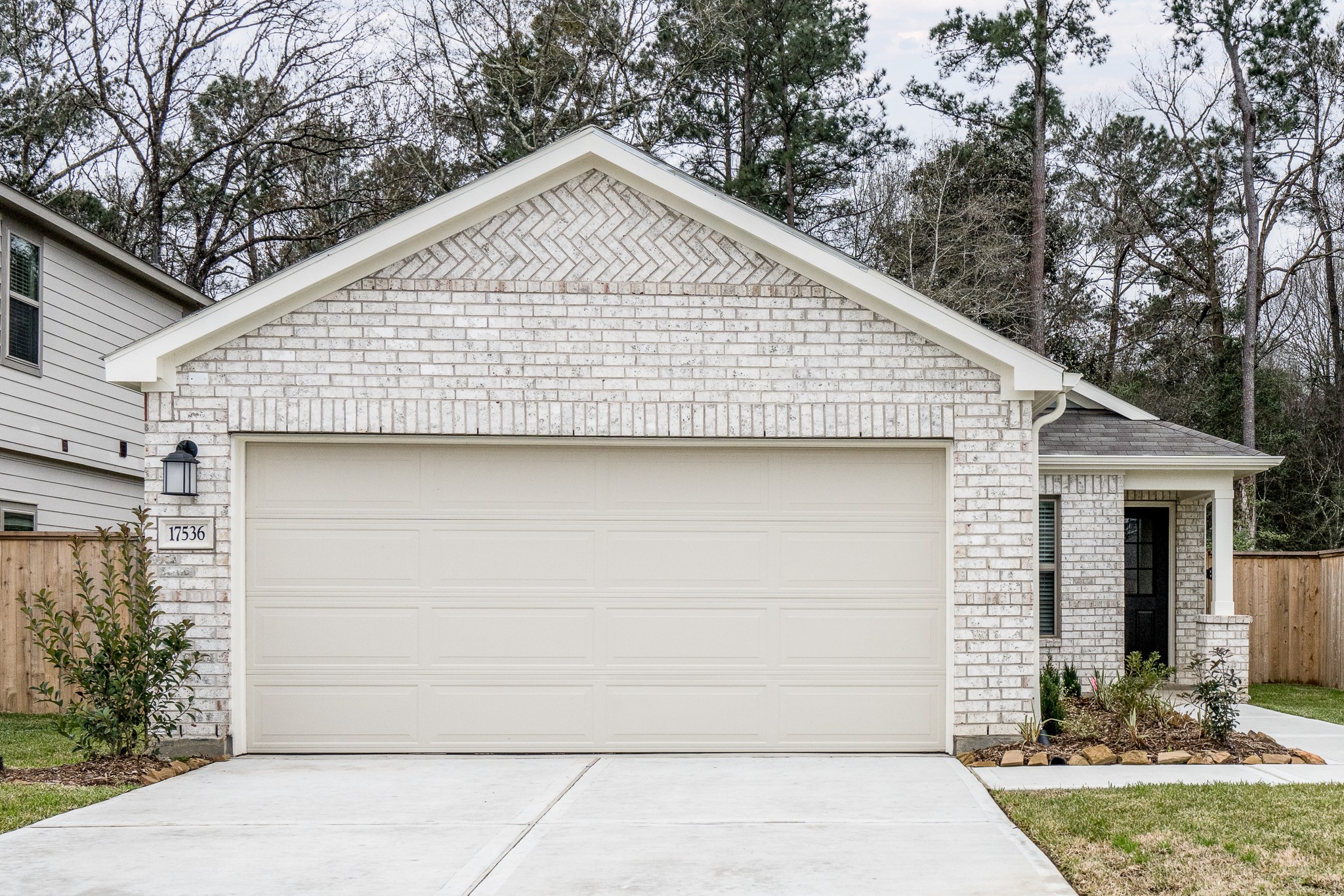 17536 Rosewood Manor Lane New Caney, TX 77357 - Photo 25 of 27 a front view of a house with a yard and garage