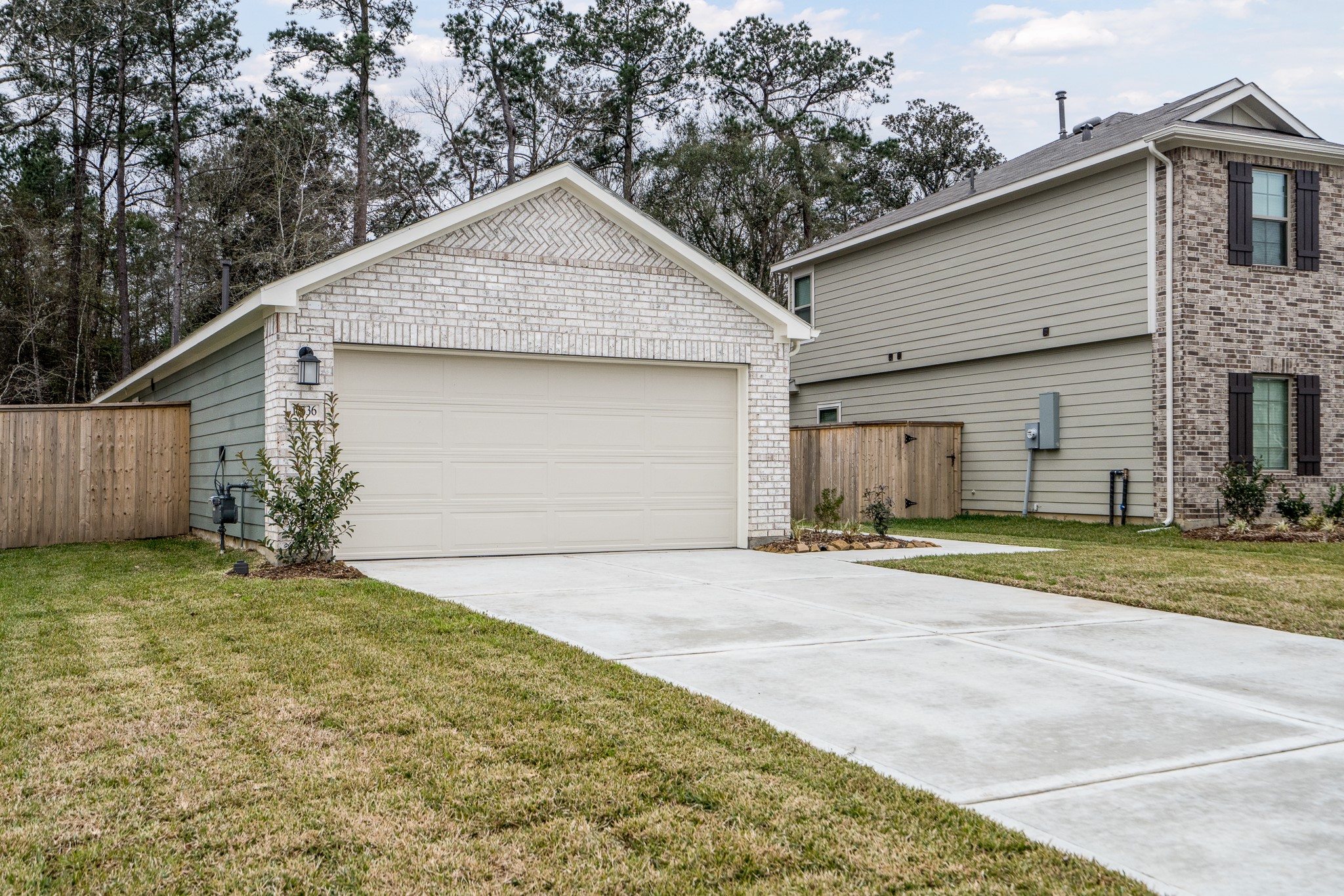 17536 Rosewood Manor Lane New Caney, TX 77357 - Photo 27 of 27 a front view of a house with a yard and garage