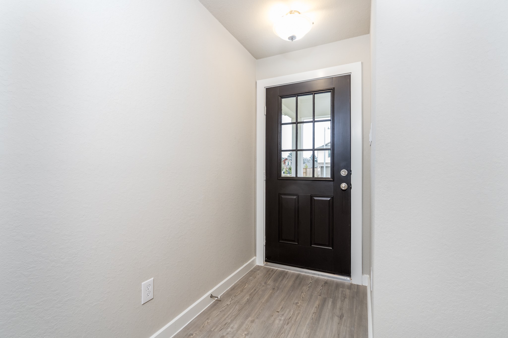 17536 Rosewood Manor Lane New Caney, TX 77357 - Photo 3 of 27 a view of an empty room with wooden floor and a window