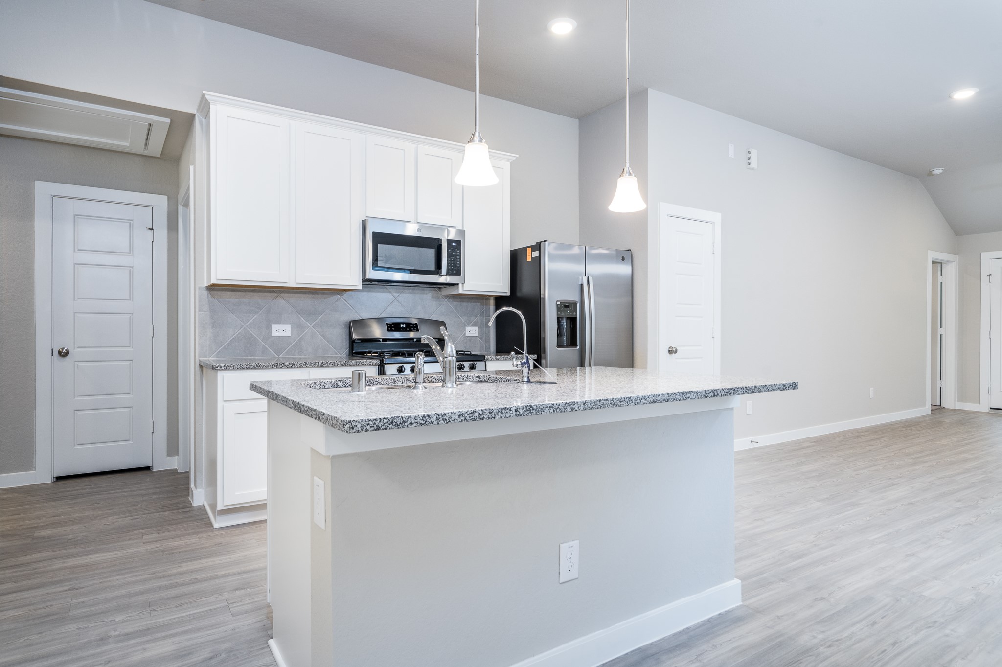 17536 Rosewood Manor Lane New Caney, TX 77357 - Photo 5 of 27 a kitchen with stainless steel appliances granite countertop a sink stove and cabinets