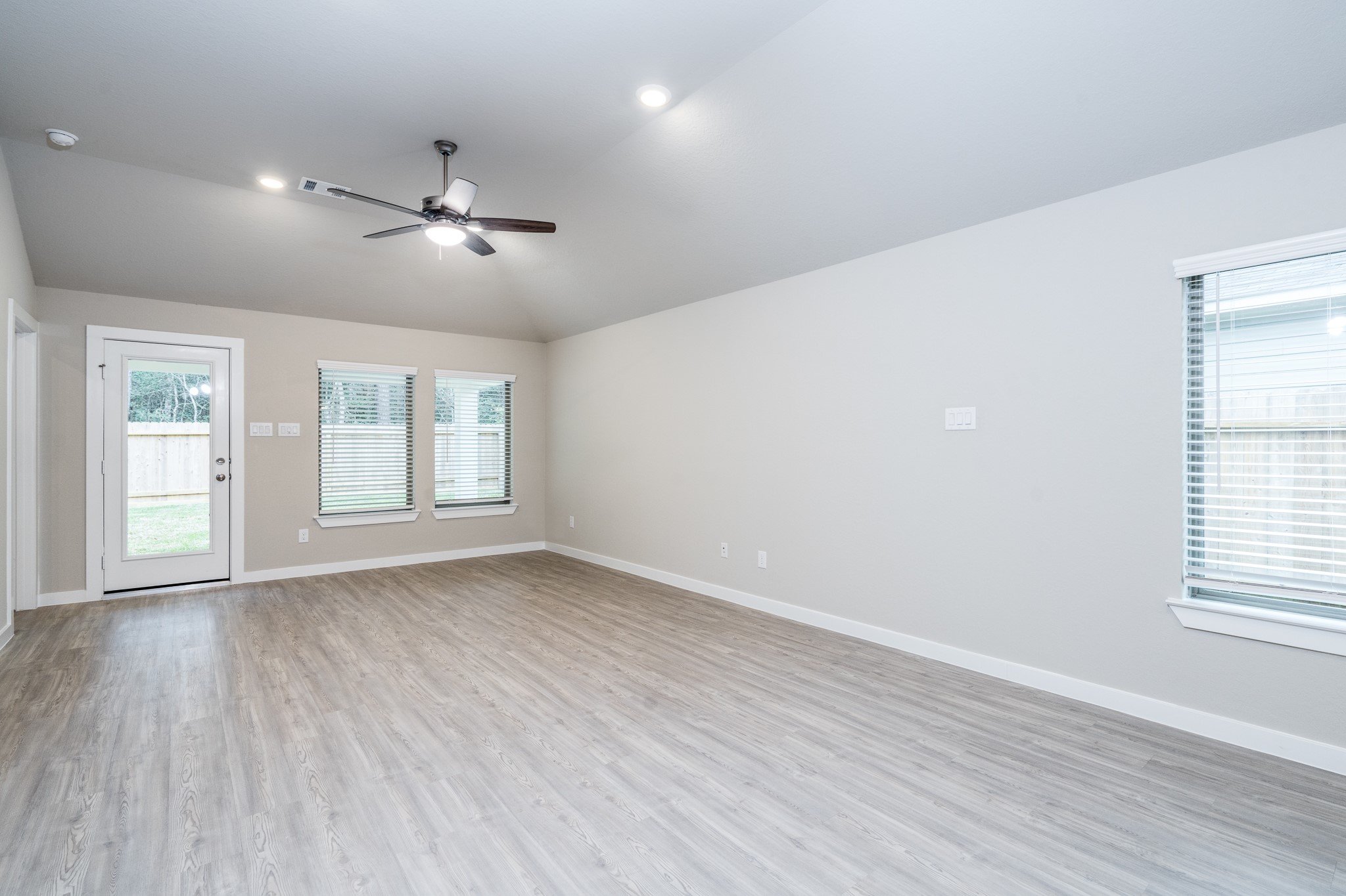 17536 Rosewood Manor Lane New Caney, TX 77357 - Photo 10 of 27 a view of empty room with wooden floor and fan