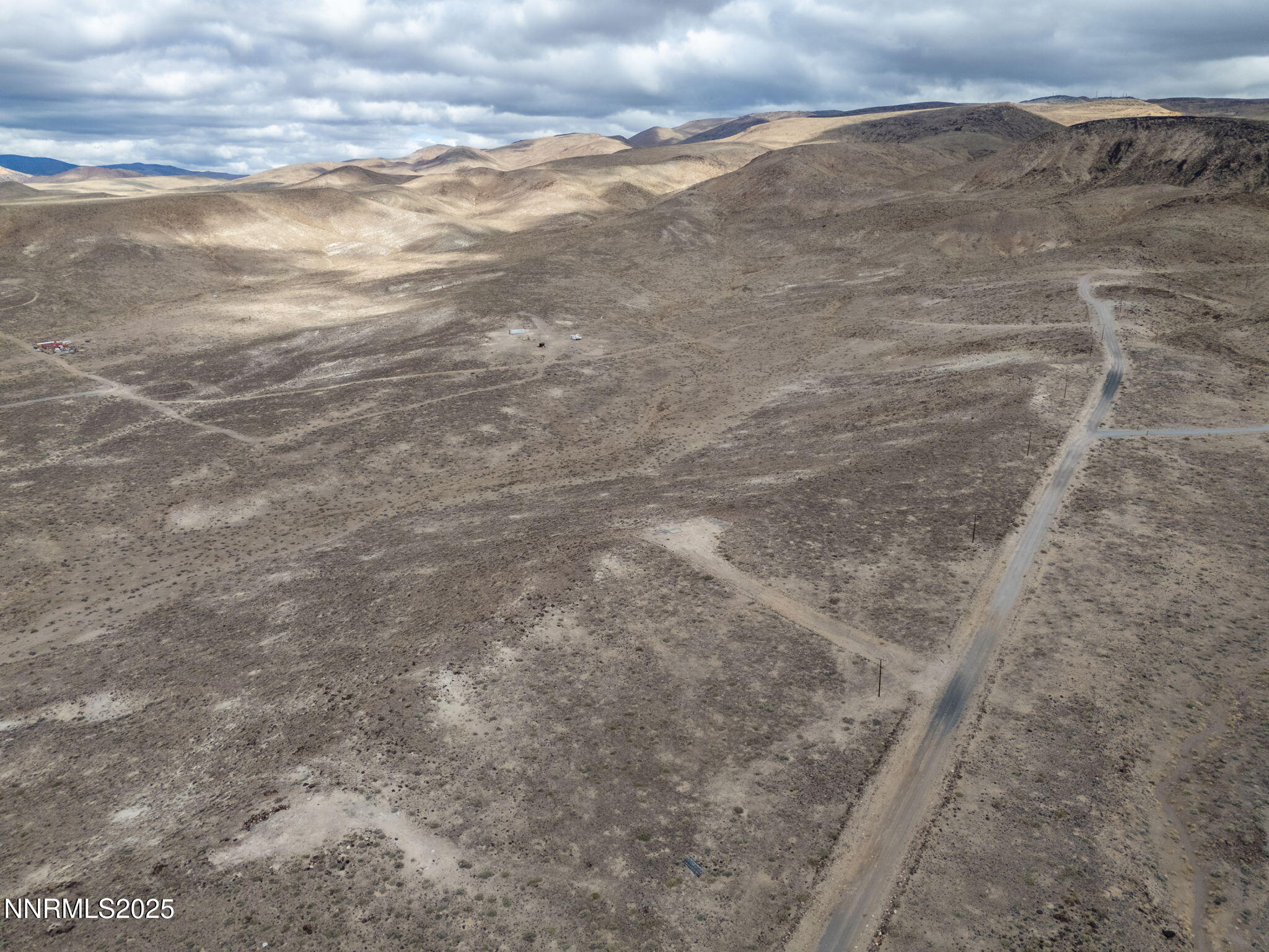 1125 Ruby Avenue Silver Springs, NV 89429 - Photo 14 of 18 a view of a dry yard with wooden floor and fence