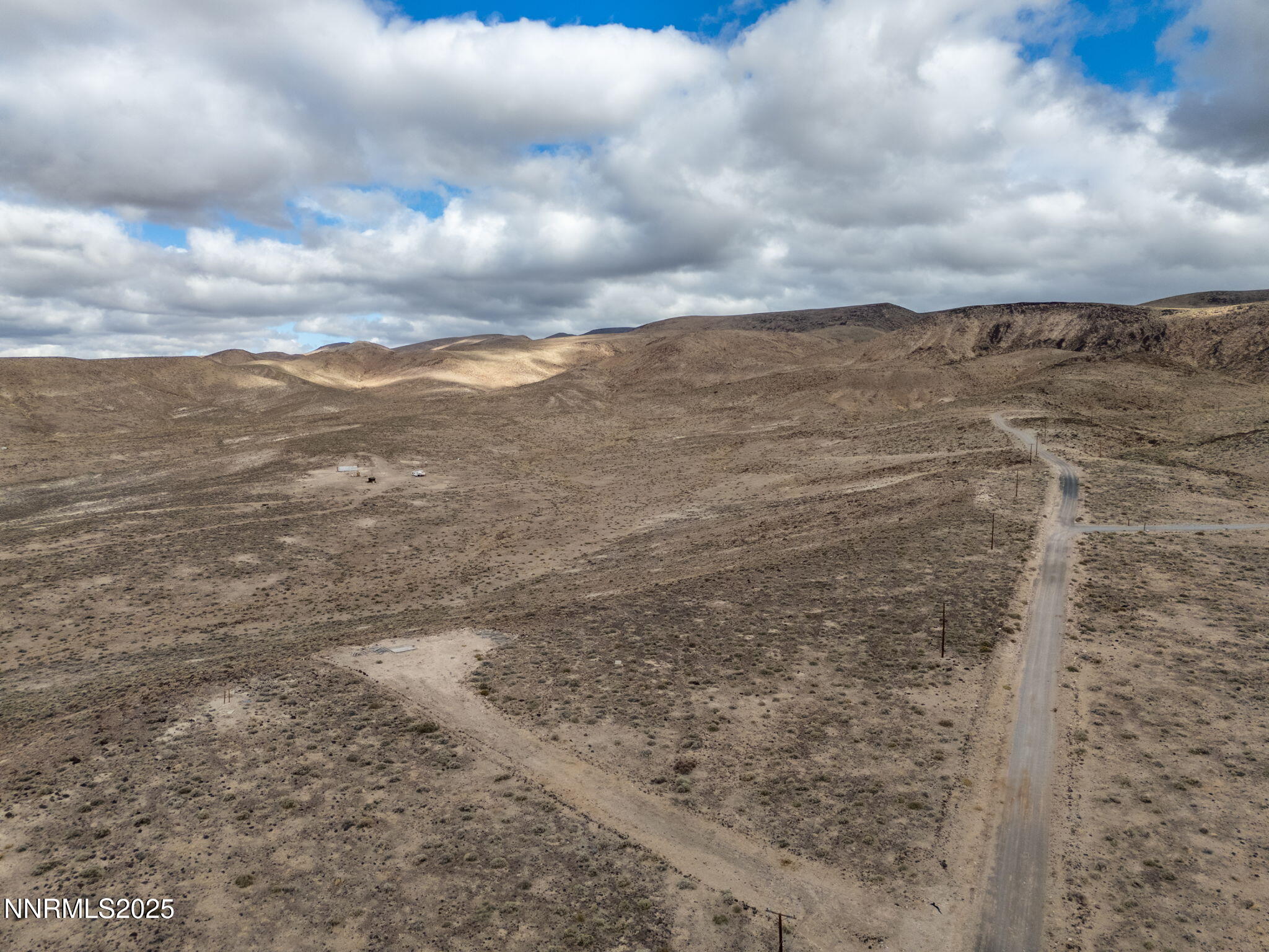 1125 Ruby Avenue Silver Springs, NV 89429 - Photo 15 of 18 a view of a dry yard with wooden fence