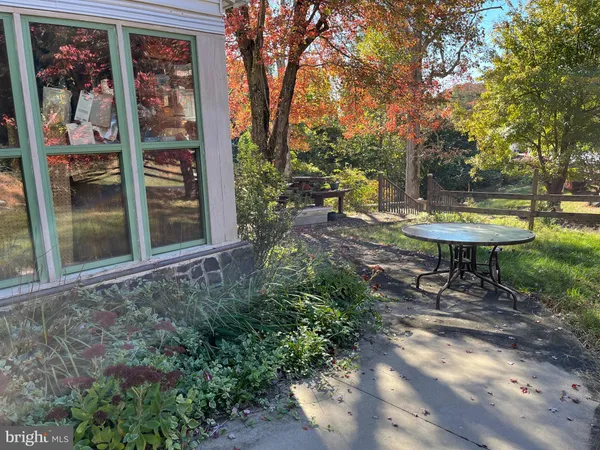 a view of a backyard with table and chairs and potted plants
