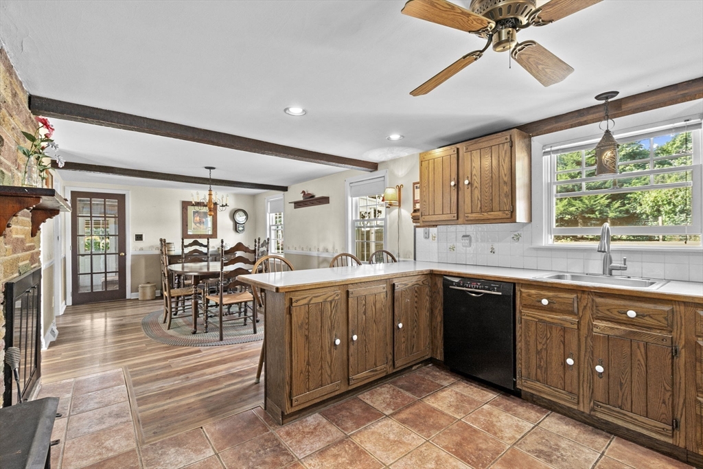 107 Tilden Road Scituate, MA 02066 - Photo 11 of 38 a kitchen with lots of counter top space and dining table