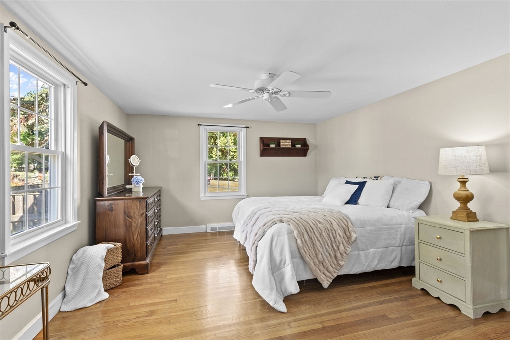 107 Tilden Road Scituate, MA 02066 - Photo 13 of 38 a bedroom with a bed and wooden floor