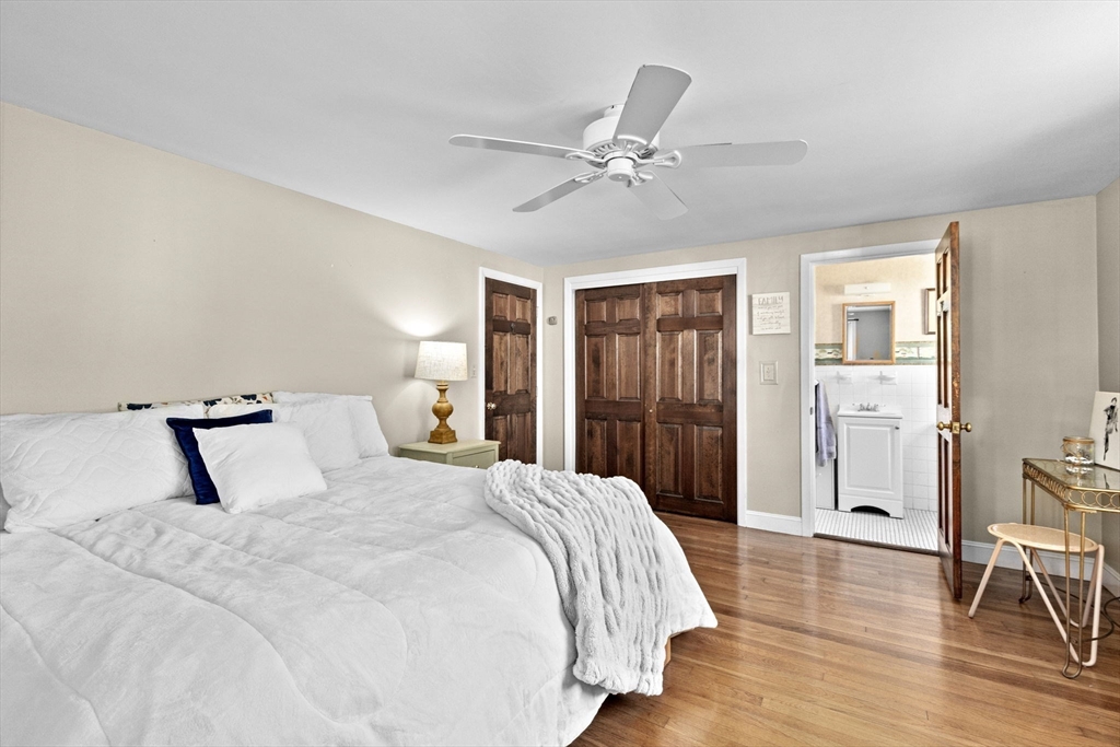 107 Tilden Road Scituate, MA 02066 - Photo 14 of 38 a bedroom with a large bed and a chandelier