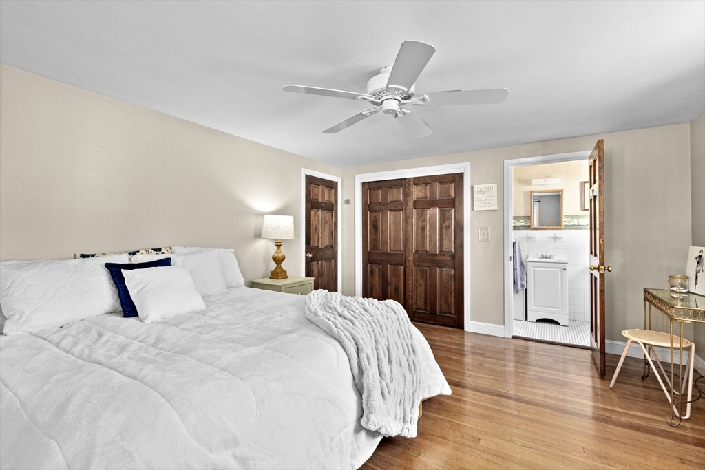 107 Tilden Road Scituate, MA 02066 - Photo 15 of 38 a bedroom with a large bed and a chandelier