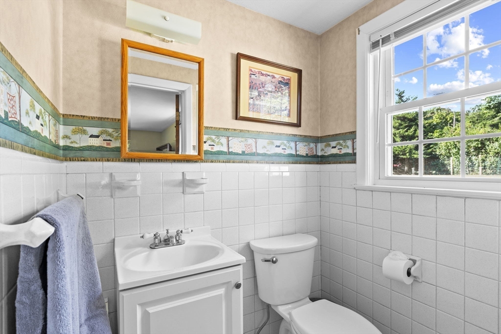 107 Tilden Road Scituate, MA 02066 - Photo 16 of 38 a bathroom with a toilet sink and mirror