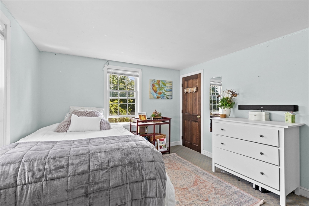 107 Tilden Road Scituate, MA 02066 - Photo 18 of 38 a bedroom with a large bed and a dresser