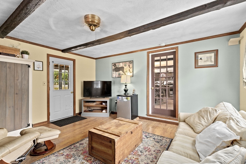 107 Tilden Road Scituate, MA 02066 - Photo 22 of 38 a bedroom with furniture and a flat screen tv