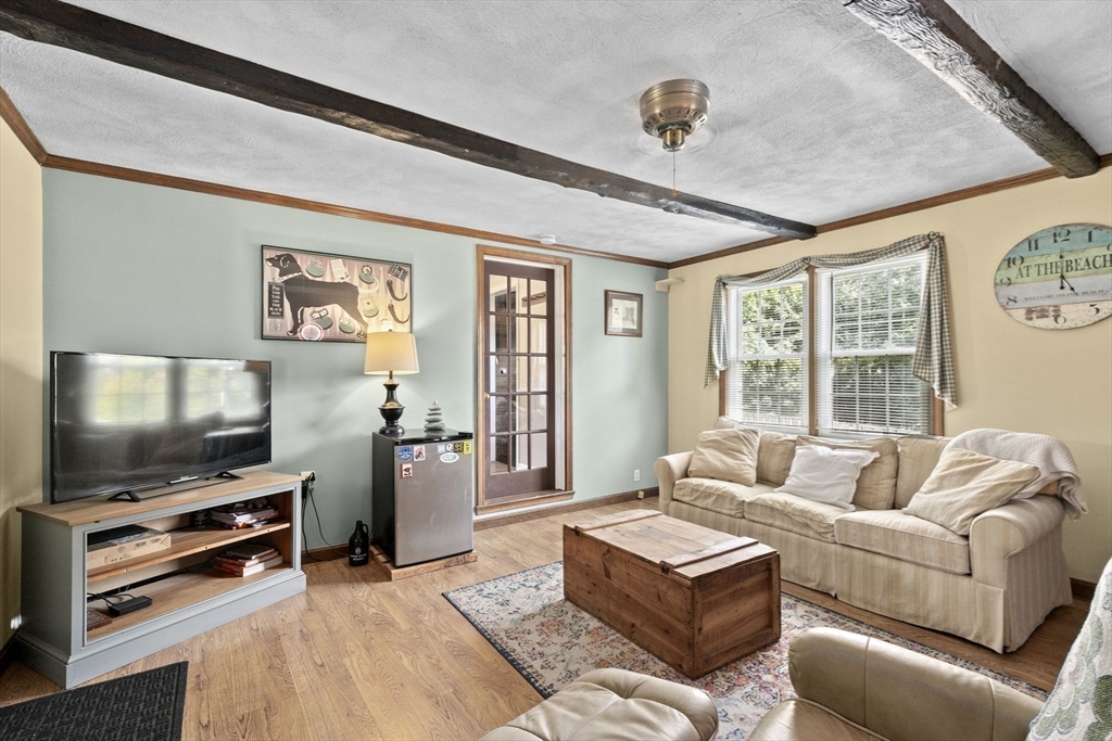 107 Tilden Road Scituate, MA 02066 - Photo 24 of 38 a living room with furniture and a flat screen tv