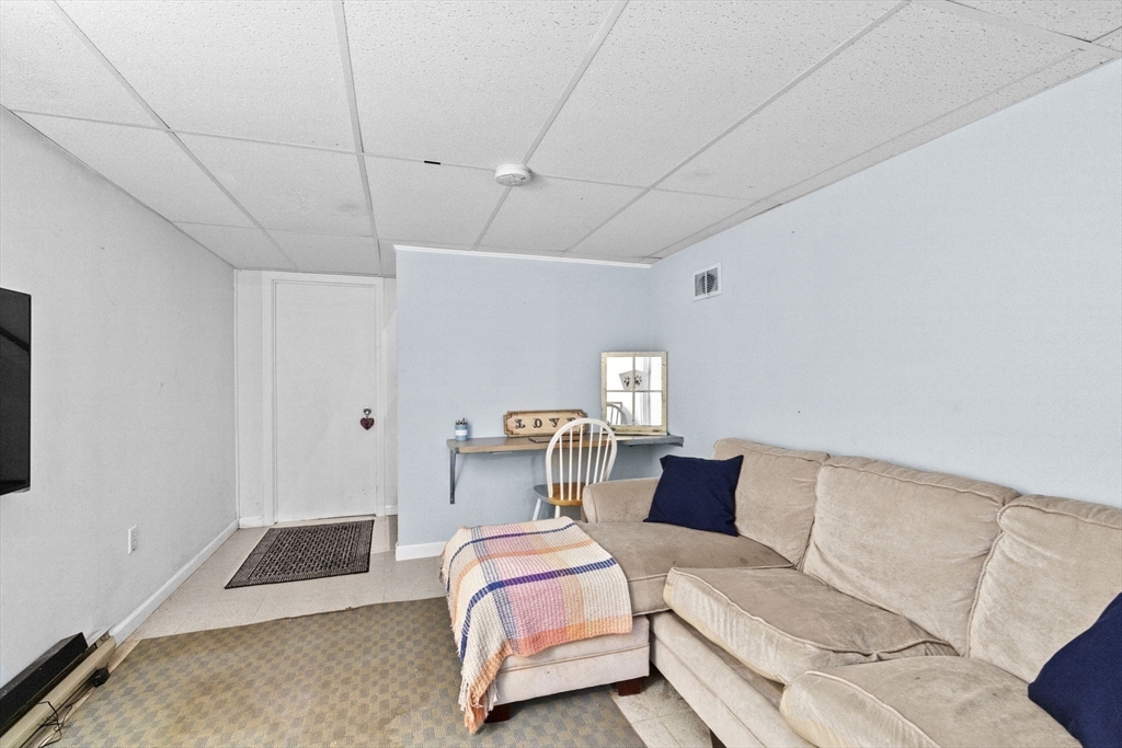 107 Tilden Road Scituate, MA 02066 - Photo 25 of 38 a bedroom with a bed and a couch