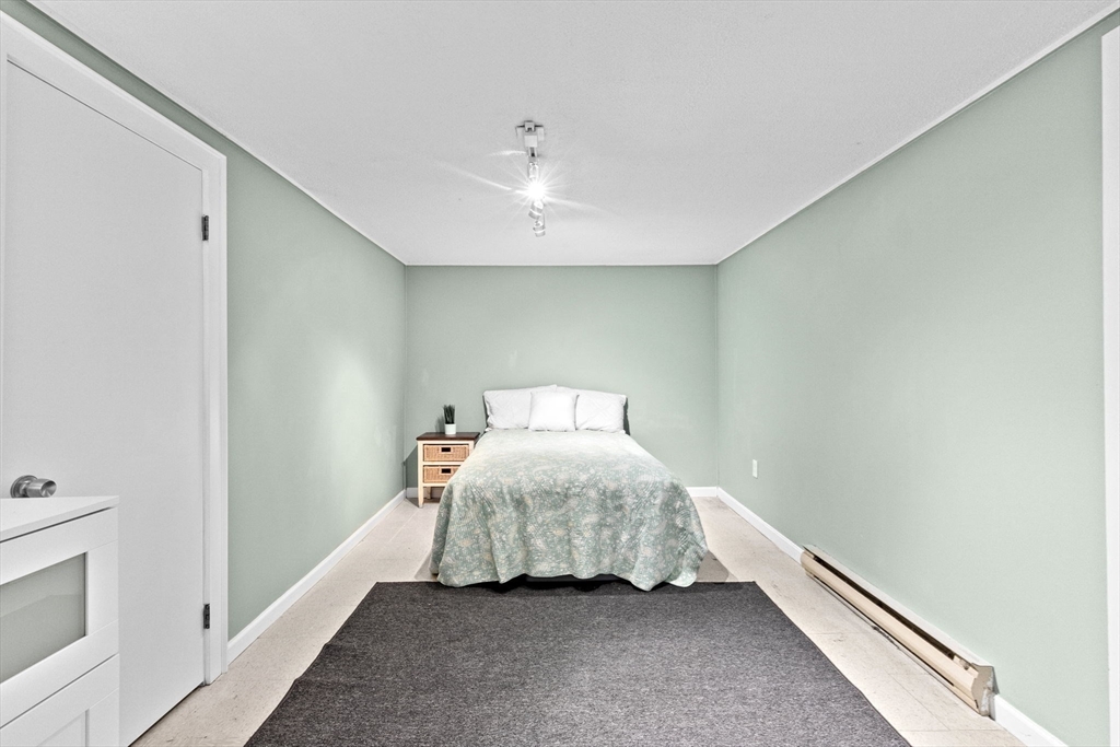 107 Tilden Road Scituate, MA 02066 - Photo 28 of 38 a bedroom with a bed and a ceiling fan