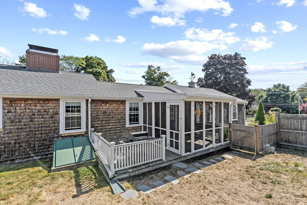 107 Tilden Road Scituate, MA 02066 - Photo 32 of 38 a view of a house with a wooden deck and furniture