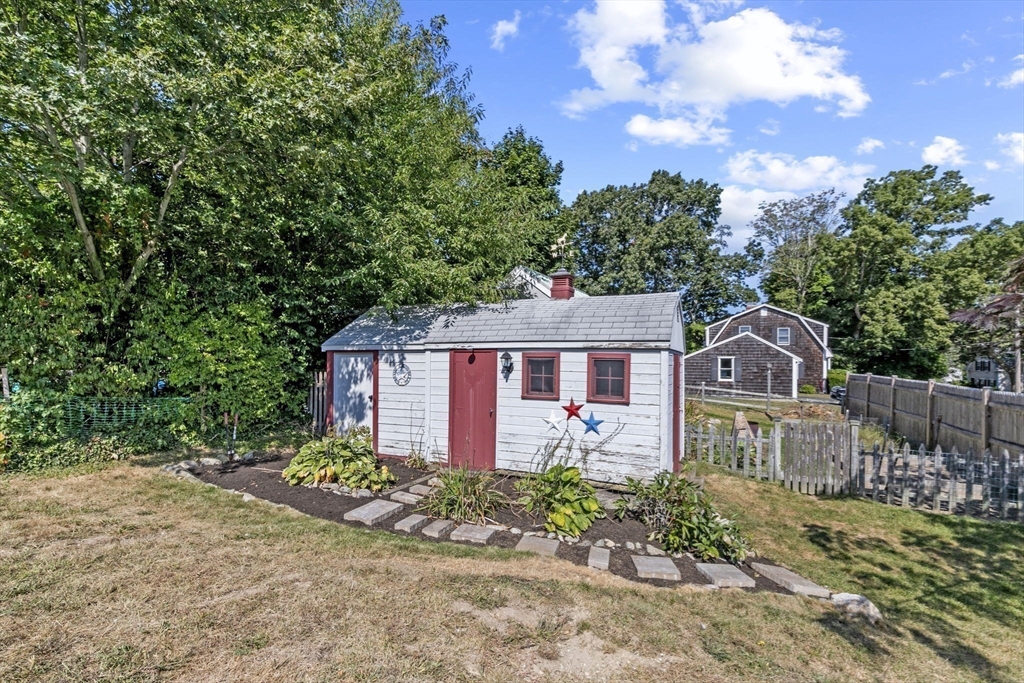 107 Tilden Road Scituate, MA 02066 - Photo 35 of 38 a front view of a house with a garden
