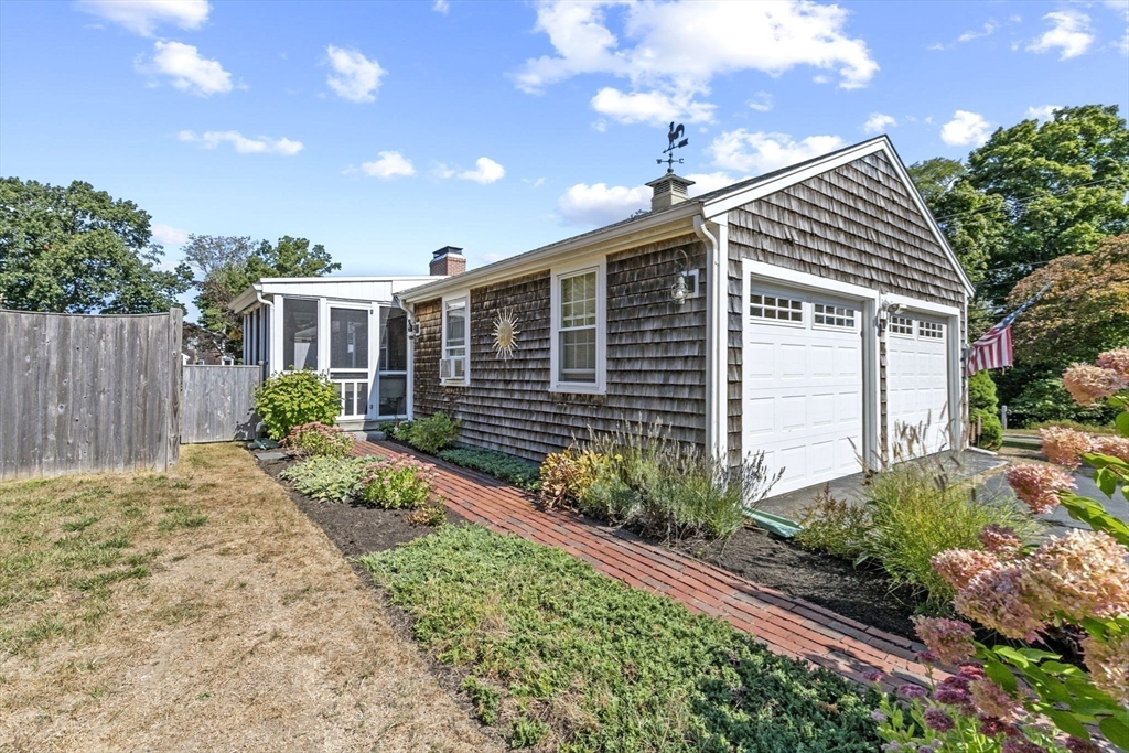 107 Tilden Road Scituate, MA 02066 - Photo 37 of 38 a front view of a house with garden