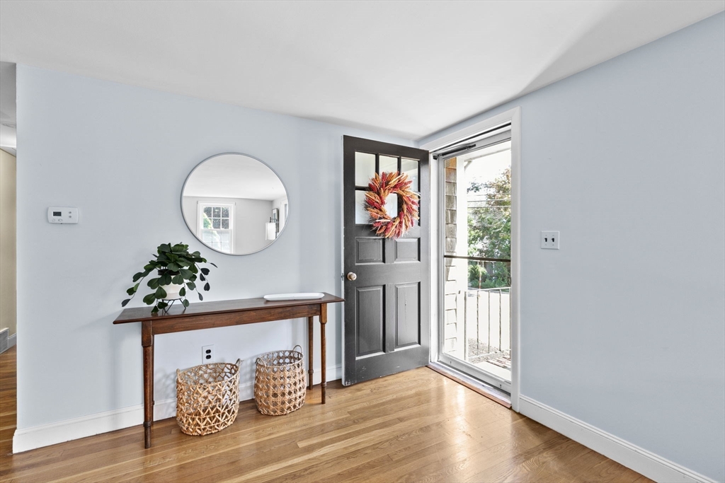 107 Tilden Road Scituate, MA 02066 - Photo 4 of 38 a room with painting on the wall and a window