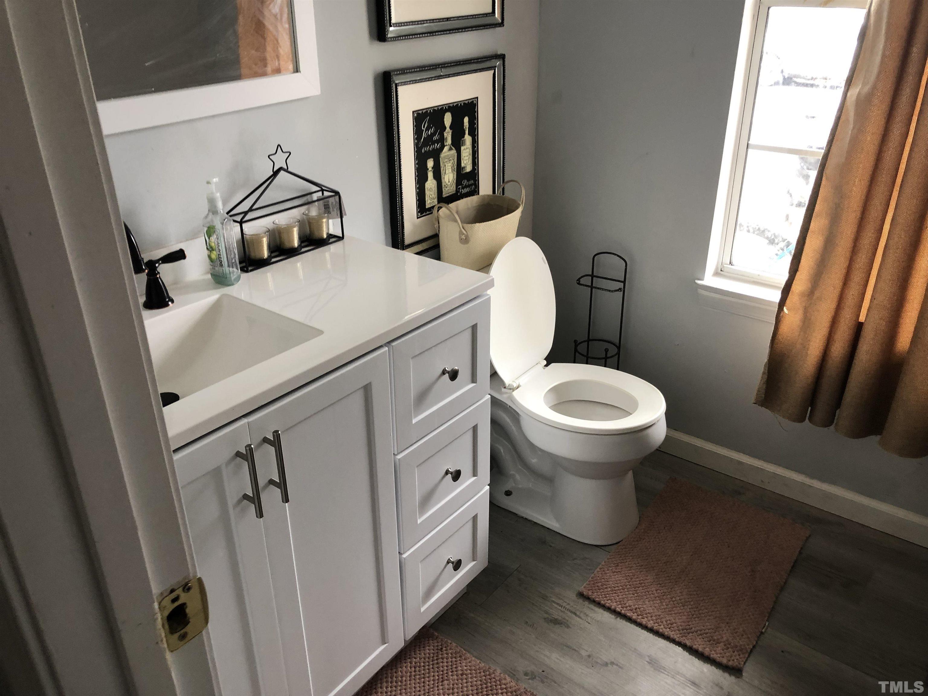 8208 Wynewood Court Raleigh, NC 27616 - Photo 2 of 10 a bathroom with a toilet sink and mirror