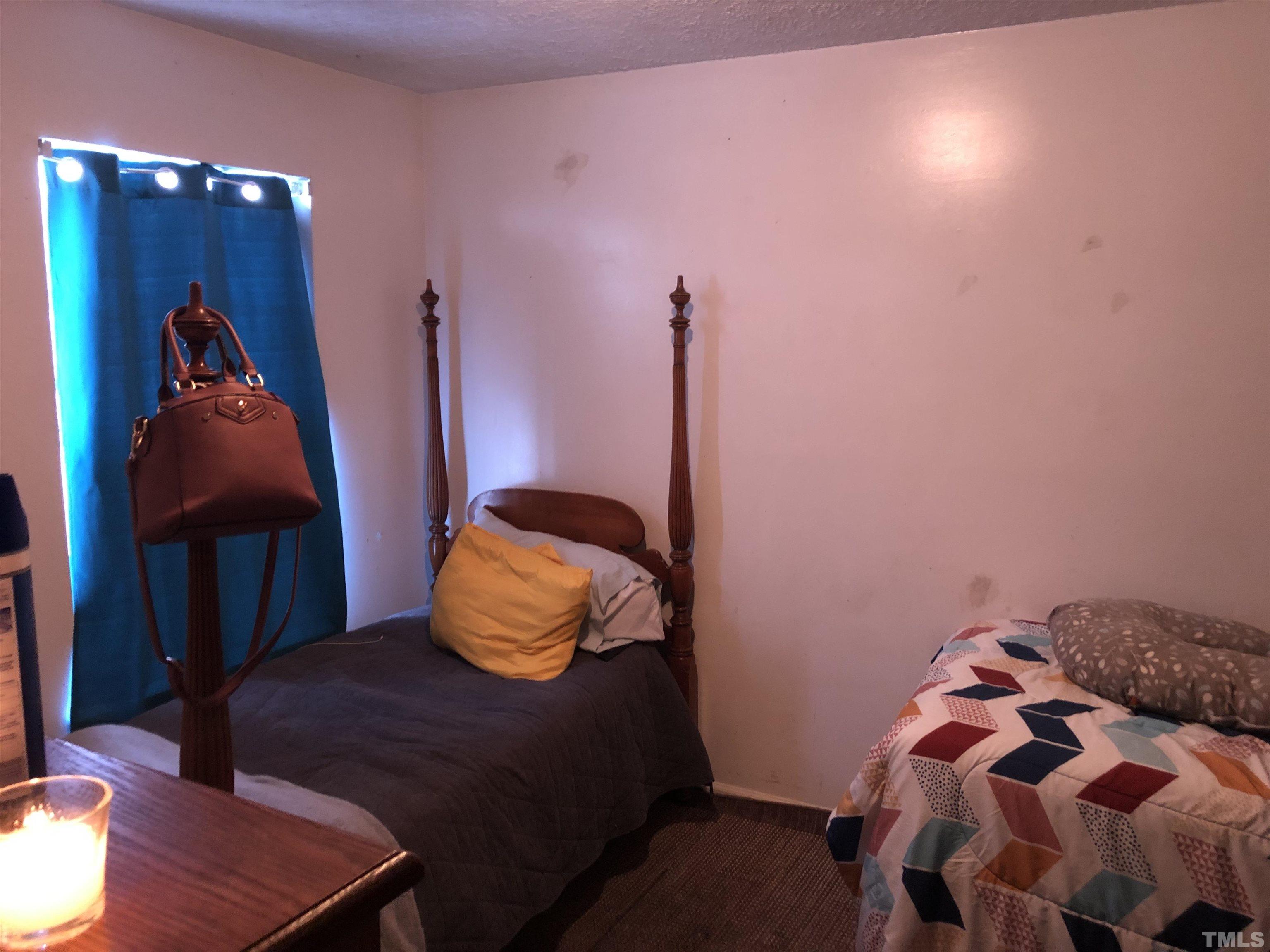 8208 Wynewood Court Raleigh, NC 27616 - Photo 8 of 10 a bedroom with a bed and wooden floor