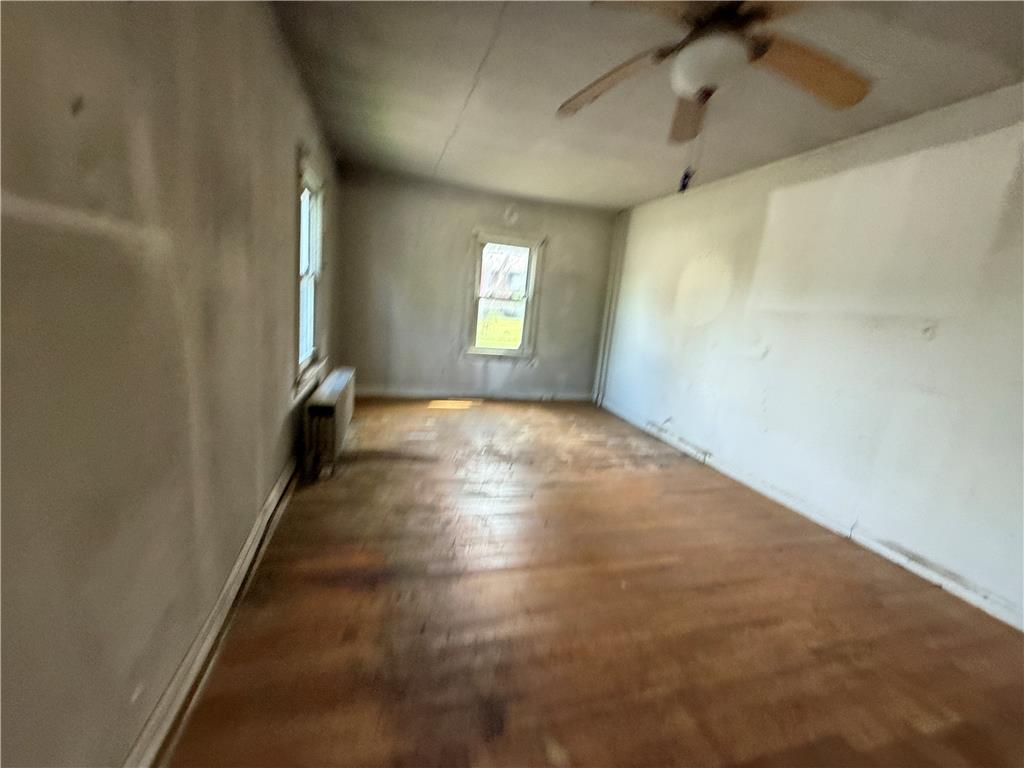 3051 Keystone Street Bethlehem, PA 18020 - Photo 13 of 18 A versatile living area features warm wood flooring and a classic ceiling fan, ready for your personal touch.