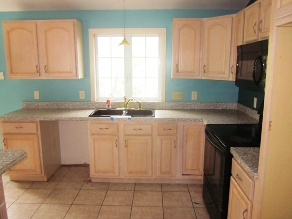 42 Third Street Worcester, MA 01602 - Photo 2 of 26 a kitchen with granite countertop a sink and a stove