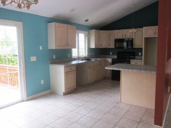 42 Third Street Worcester, MA 01602 - Photo 7 of 26 a kitchen with stainless steel appliances granite countertop a stove a sink and a microwave