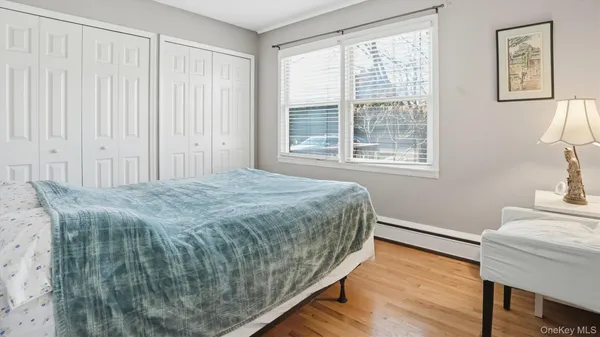 a spacious bedroom with a bed and a window