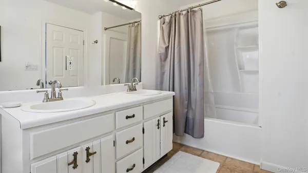 a bathroom with a double vanity sink and mirror