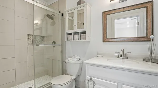 a bathroom with a toilet sink and shower