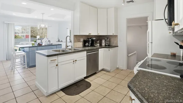 a kitchen with stainless steel appliances granite countertop a sink and cabinets